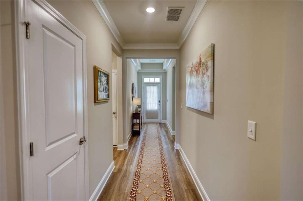 479 Glenmont Road Grayson, GA 30017 - Photo 5 of 58 a view of a hallway with wooden floor and staircase