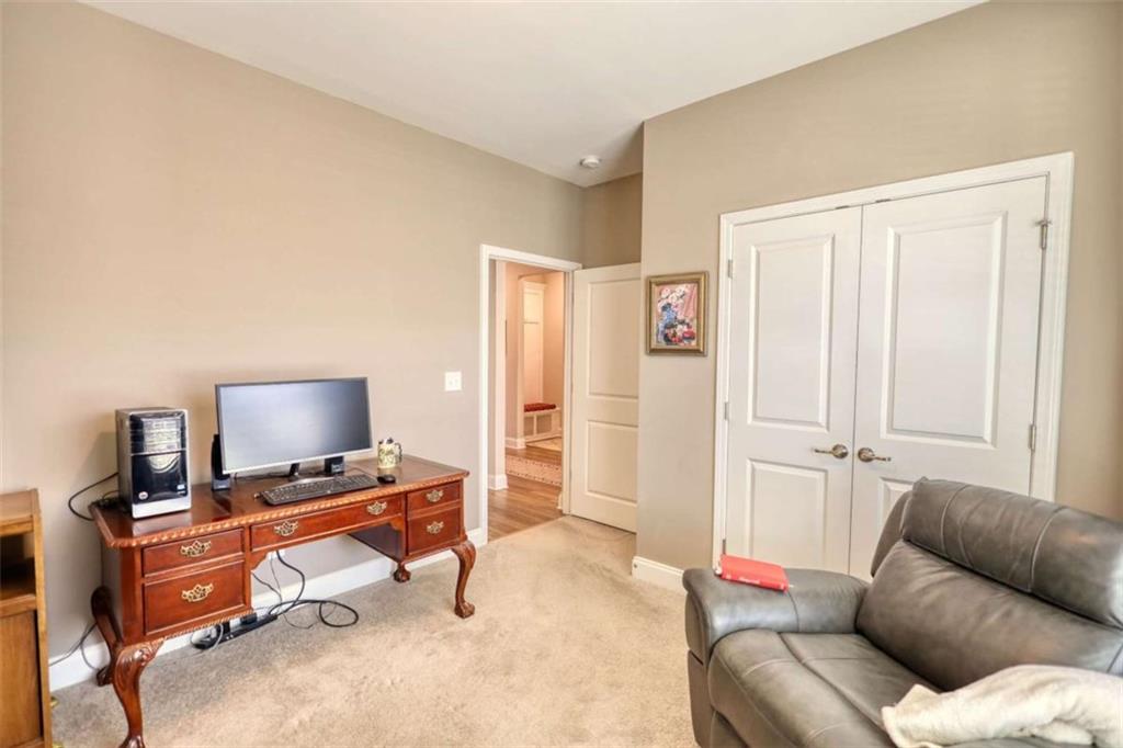 479 Glenmont Road Grayson, GA 30017 - Photo 10 of 58 a living room with furniture and a flat screen tv
