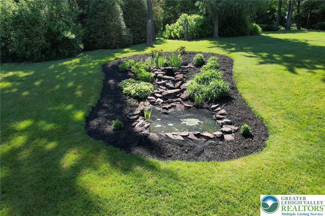 3470 Brodhead Road Bethlehem, PA 18020 - Photo 27 of 84 An inviting water feature with natural stone and lush plantings anchors a well-maintained lawn.