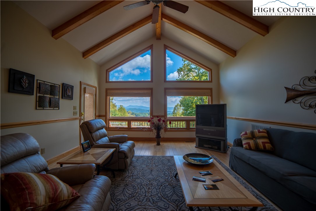 516 Miners Ridge Trail Banner Elk, NC 28604 - Photo 23 of 29 a living room with furniture and a floor to ceiling window