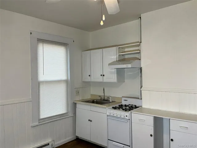 a kitchen with stainless steel appliances granite countertop a sink stove and cabinets