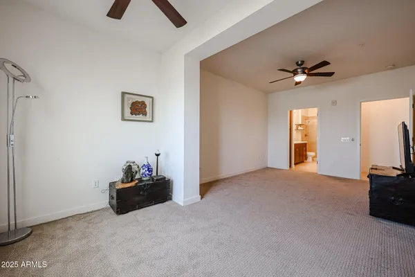a view of an empty room with a ceiling fan