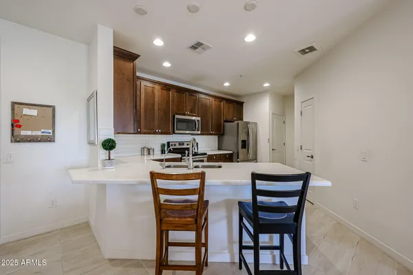 a kitchen with sink a microwave and refrigerator