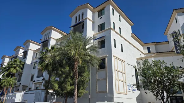 a front view of a building with a tree