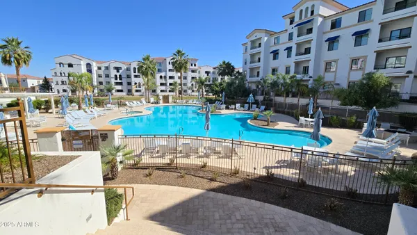 a view of a swimming pool with outdoor seating