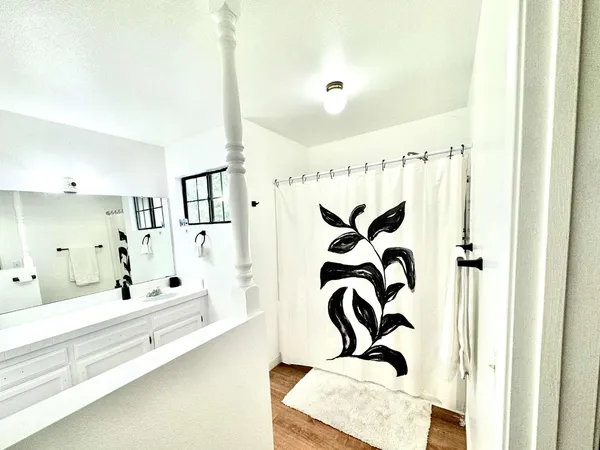 a bathroom with a bathtub and a shower