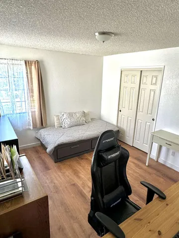 a bedroom with a bed and a mirror