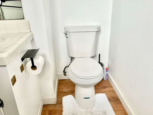 a bathroom with a toilet and a mirror