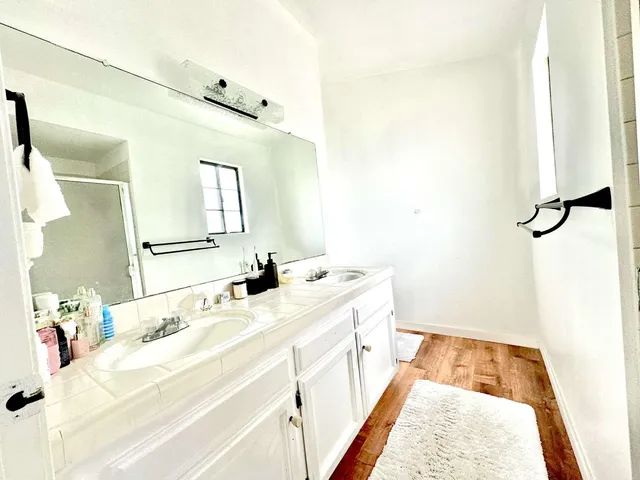 a bathroom with a tub sink and mirror
