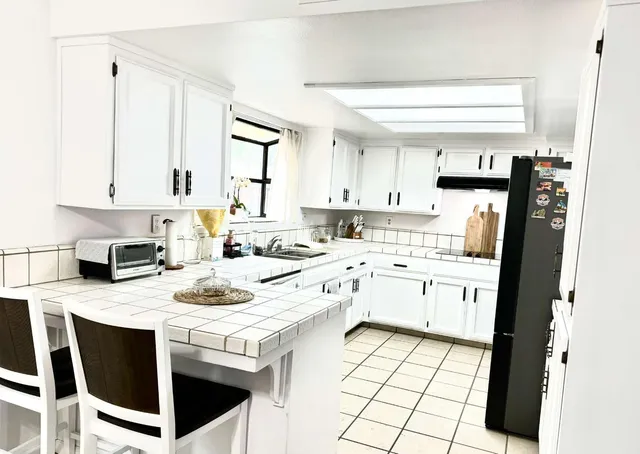 a kitchen with a stove a sink and a refrigerator