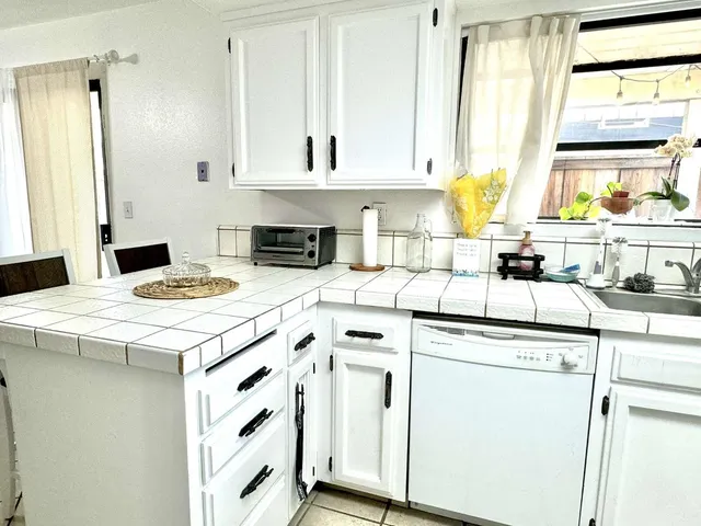 a kitchen with appliances cabinets and a sink
