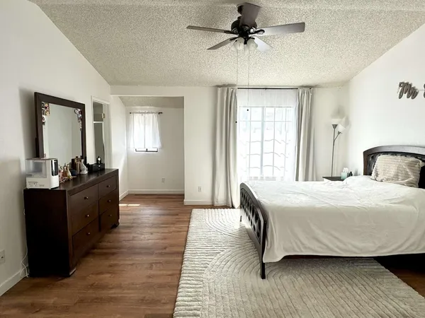 a bedroom with a bed and wooden floor