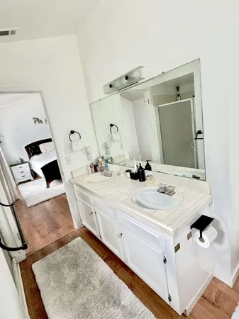 a bathroom with a sink vanity and mirror
