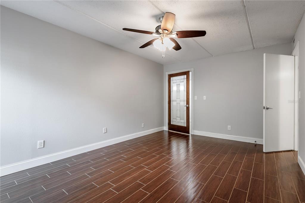 3325 Bayshore Boulevard, Unit A17 Tampa, FL 33629 - Photo 11 of 31 an empty room with wooden floor and windows