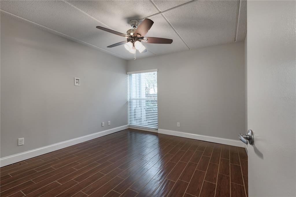 3325 Bayshore Boulevard, Unit A17 Tampa, FL 33629 - Photo 17 of 31 a view of an empty room with wooden floor and a window