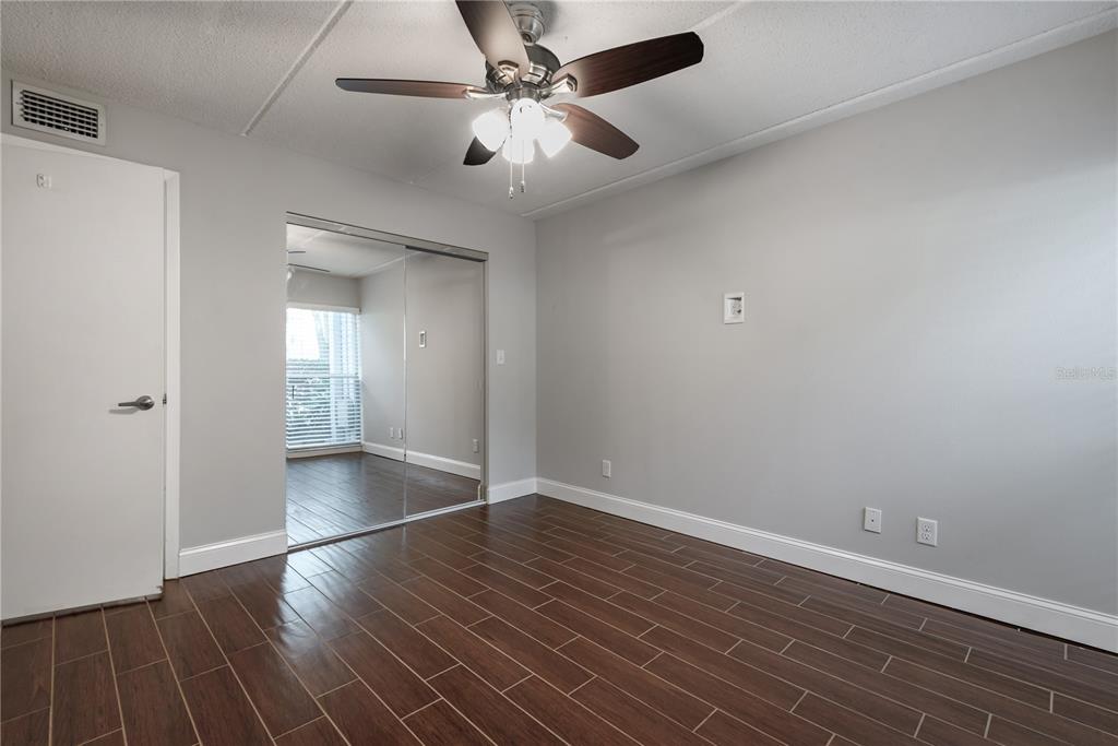 3325 Bayshore Boulevard, Unit A17 Tampa, FL 33629 - Photo 18 of 31 an empty room with wooden floor and windows