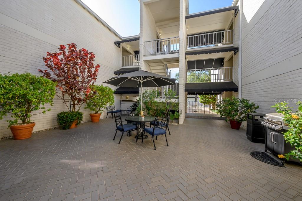 3325 Bayshore Boulevard, Unit A17 Tampa, FL 33629 - Photo 26 of 31 a view of a patio with table and chairs and potted plants