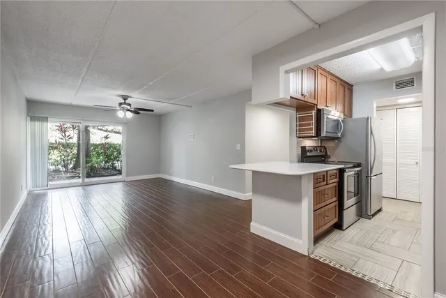 a kitchen with a refrigerator and a stove