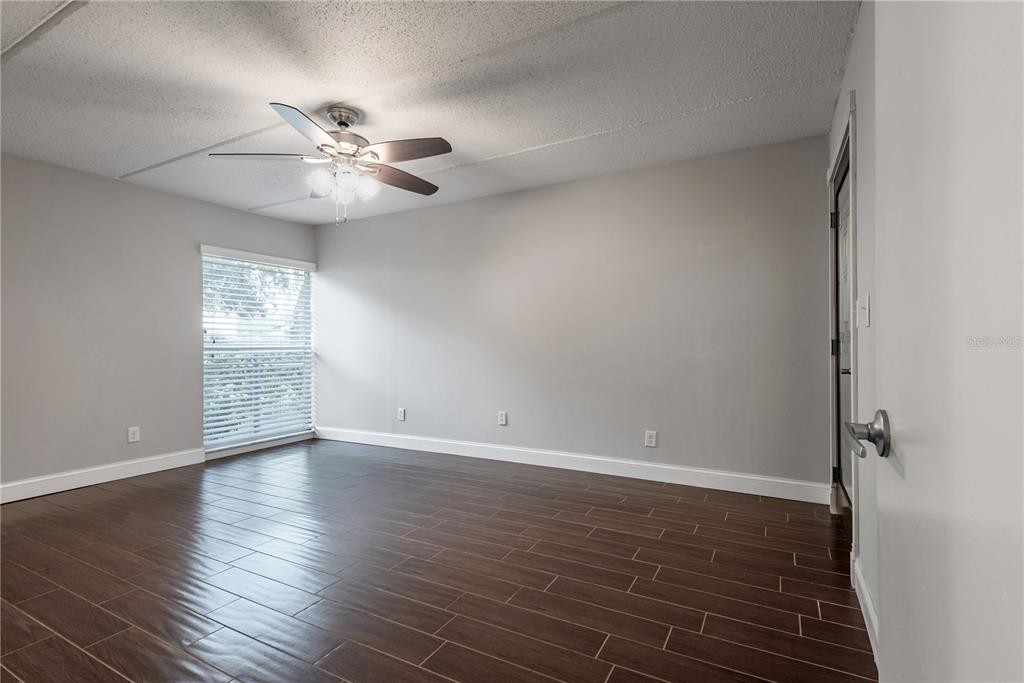 3325 Bayshore Boulevard, Unit A17 Tampa, FL 33629 - Photo 10 of 31 a view of an empty room with wooden floor and a window