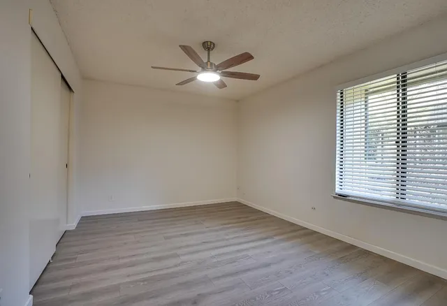 a view of a room with wooden floor and windows