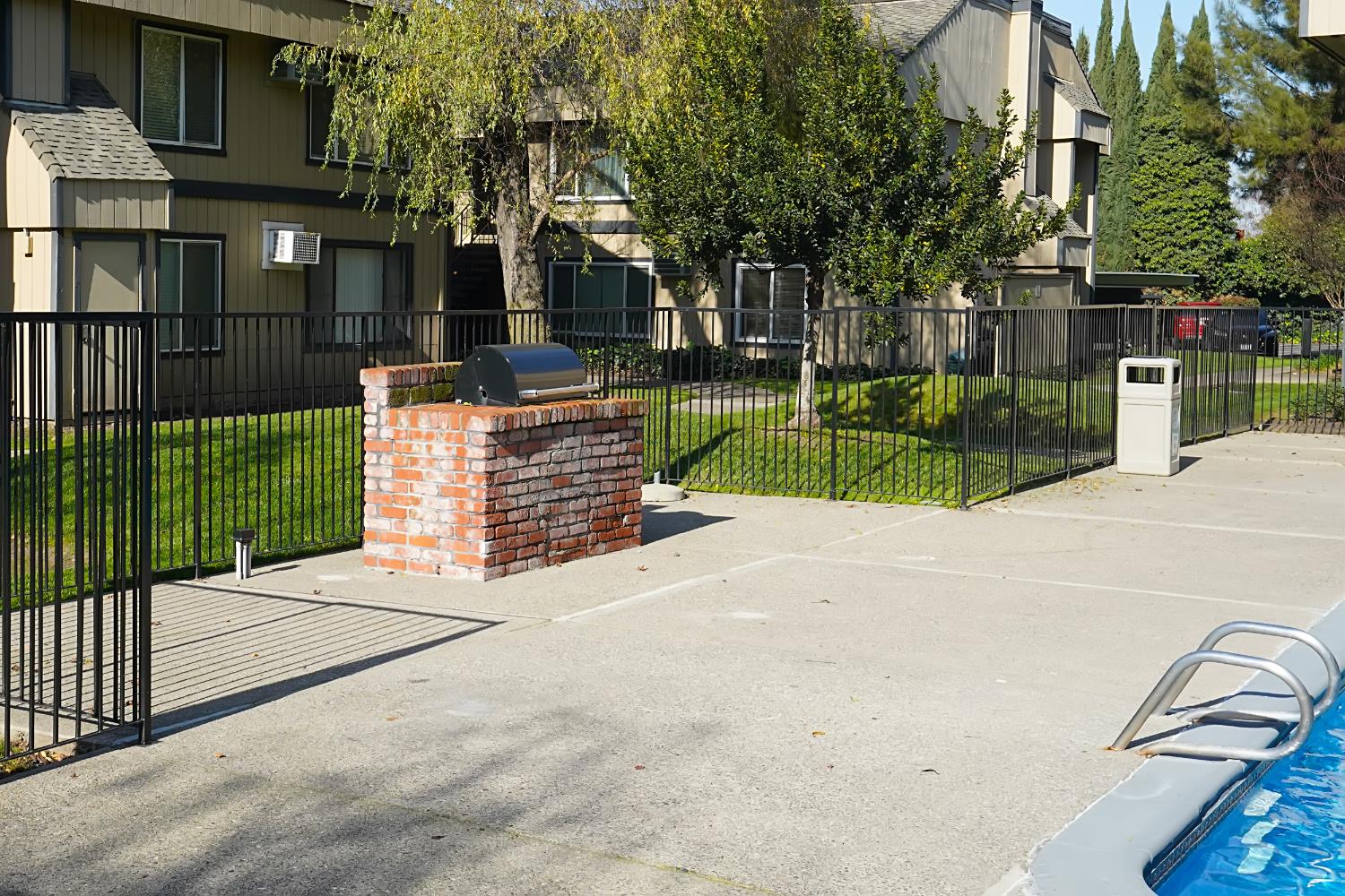 6724 Plymouth Road, Unit 88 Stockton, CA 95207 - Photo 20 of 21 a view of a backyard with brick wall and potted plants