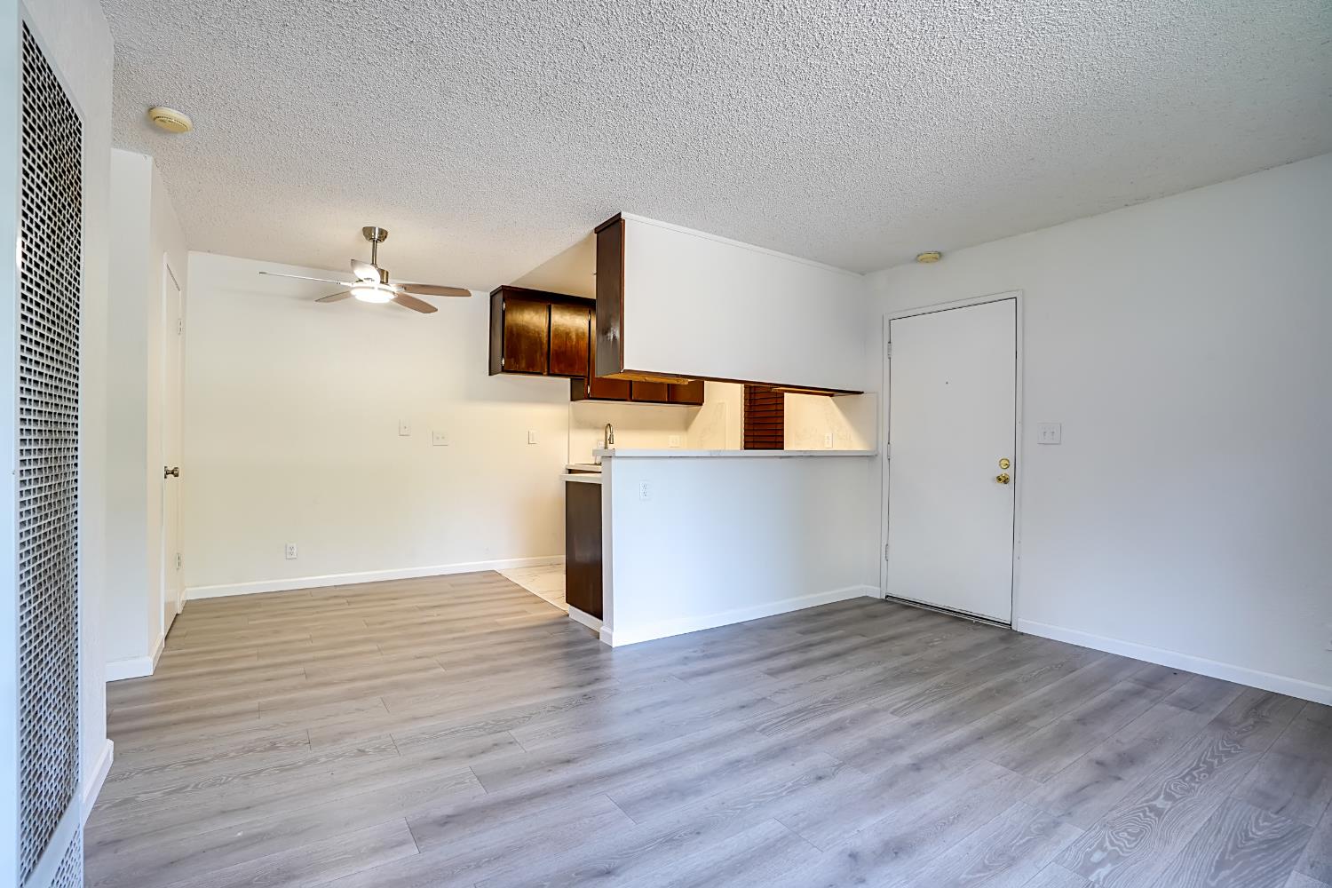 6724 Plymouth Road, Unit 88 Stockton, CA 95207 - Photo 6 of 21 wooden floor in an empty room with a window