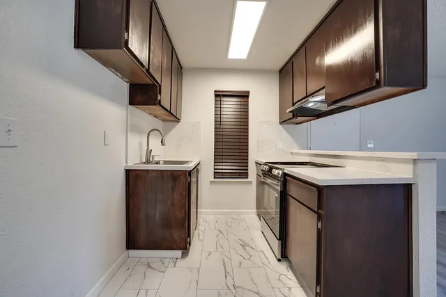 a kitchen with a sink cabinets and entryway