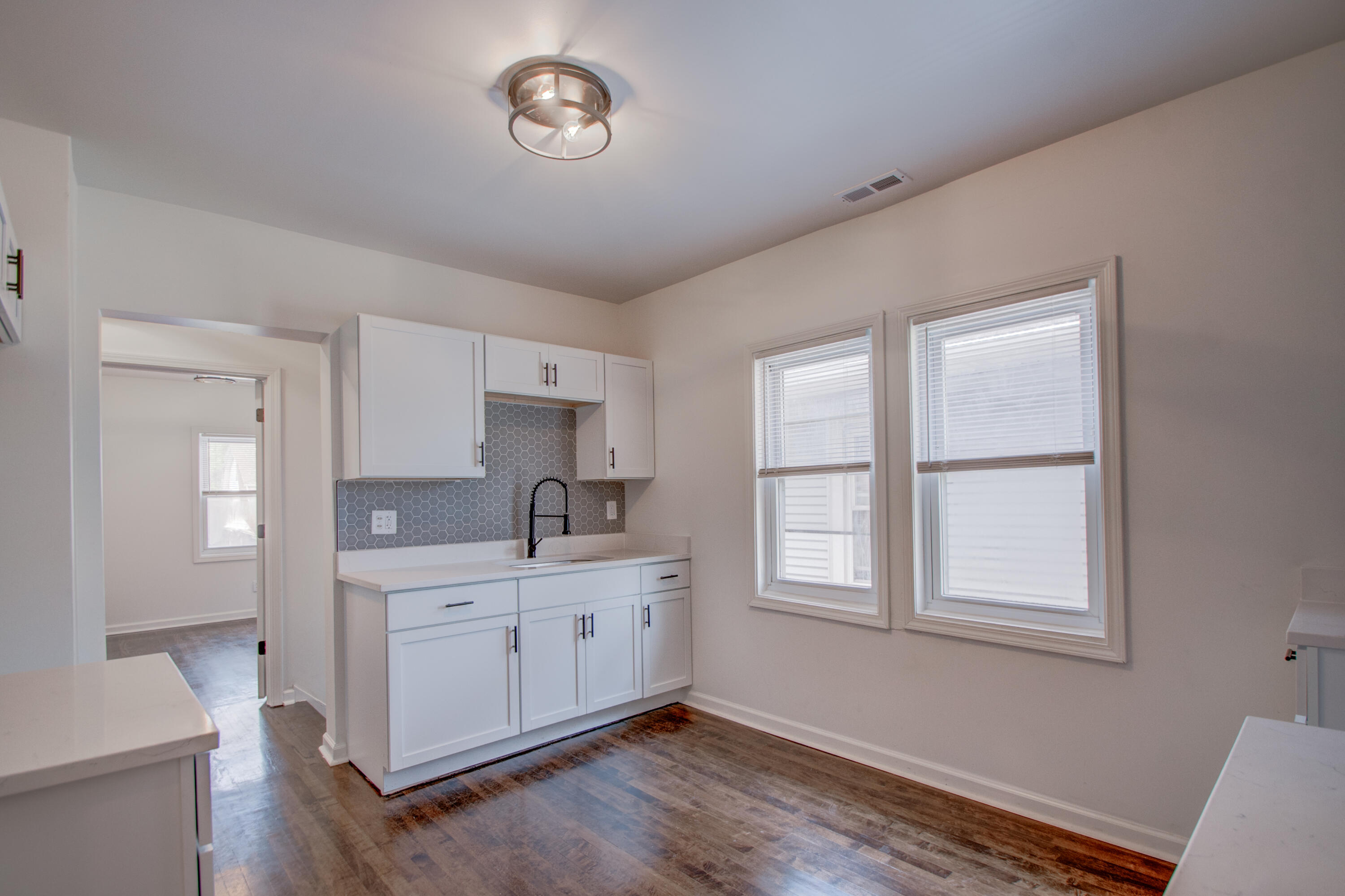613 Tennessee Street Gary, IN 46402 - Photo 17 of 39 a kitchen with a sink window and cabinets