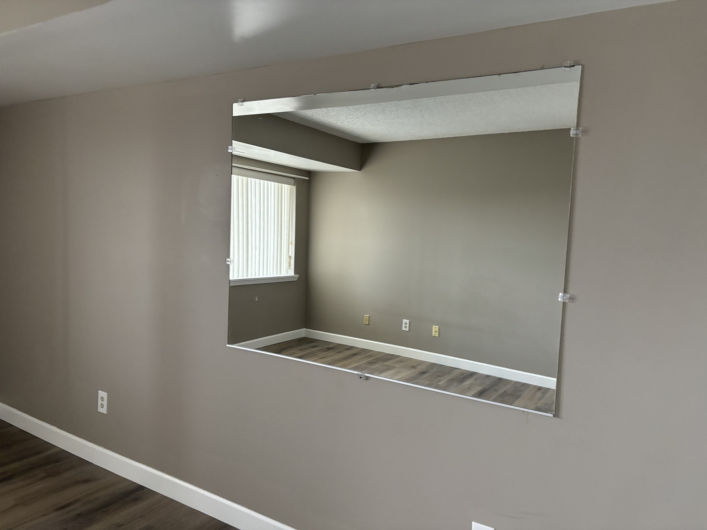 1133 North 7th Street, Unit 608 Rochelle, IL 61068 - Photo 25 of 43 a view of an empty room with wooden floor and a window
