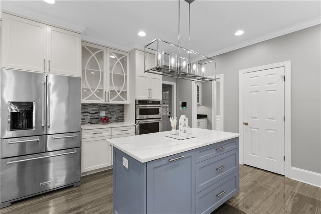 1225 Mobile Way Grayson, GA 30017 - Photo 17 of 51 a kitchen with a refrigerator a sink and dishwasher a oven with wooden floor