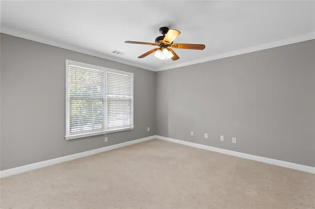 a view of a livingroom with a fireplace cabinet and window