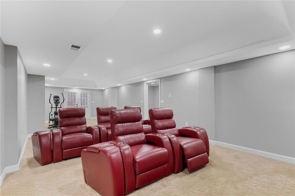 1225 Mobile Way Grayson, GA 30017 - Photo 38 of 51 a media room with lots of chairs and a projector screen