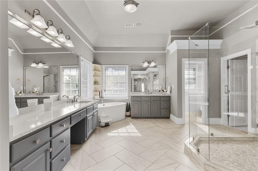 1225 Mobile Way Grayson, GA 30017 - Photo 5 of 51 a large bathroom with a double vanity sink a mirror and a bathtub