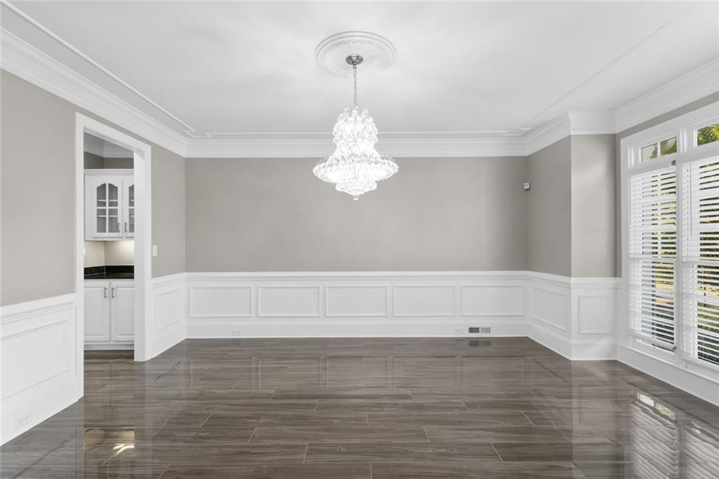 1225 Mobile Way Grayson, GA 30017 - Photo 10 of 51 a view of an empty room with wooden floor and a window