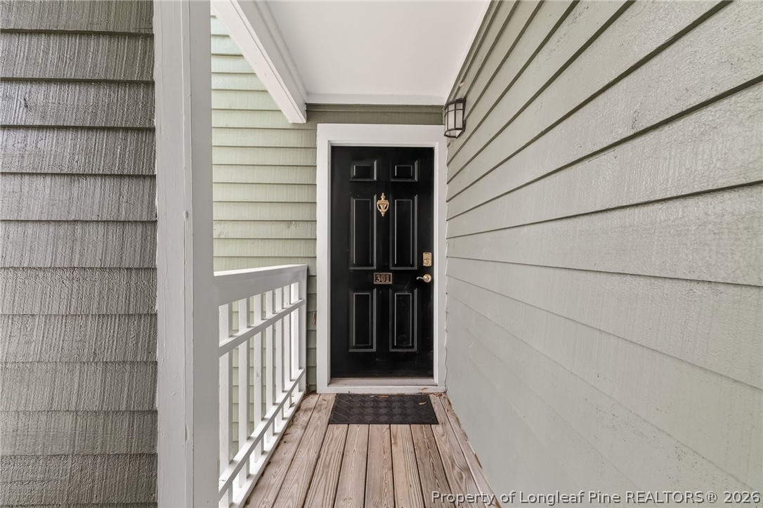 1221 Westview Lane, Unit 301 Raleigh, NC 27605 - Photo 4 of 32 a view of a house with a door and wooden floor