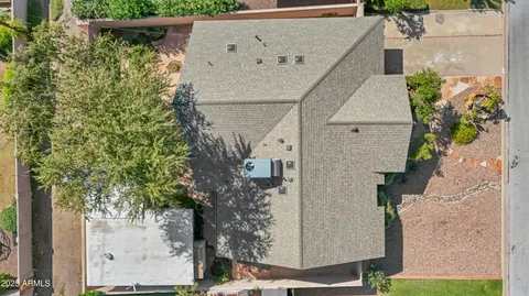 an aerial view of a house with a yard