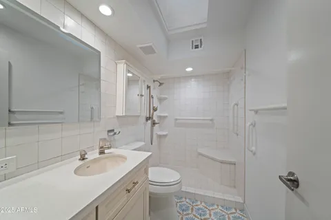 a bathroom with a sink toilet and shower