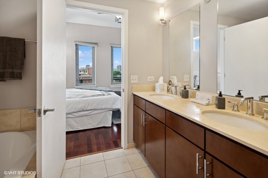 3920 North Sheridan Road, Unit 504 Chicago, IL 60613 - Photo 15 of 21 a en suite bathroom with a sink and a mirror