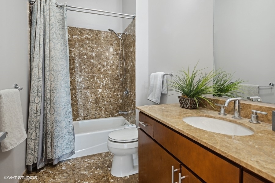 3920 North Sheridan Road, Unit 504 Chicago, IL 60613 - Photo 18 of 21 a bathroom with a granite countertop sink toilet and shower