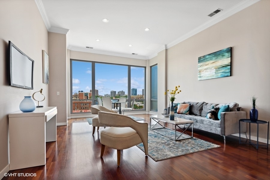 3920 North Sheridan Road, Unit 504 Chicago, IL 60613 - Photo 2 of 21 a living room with furniture and a large window