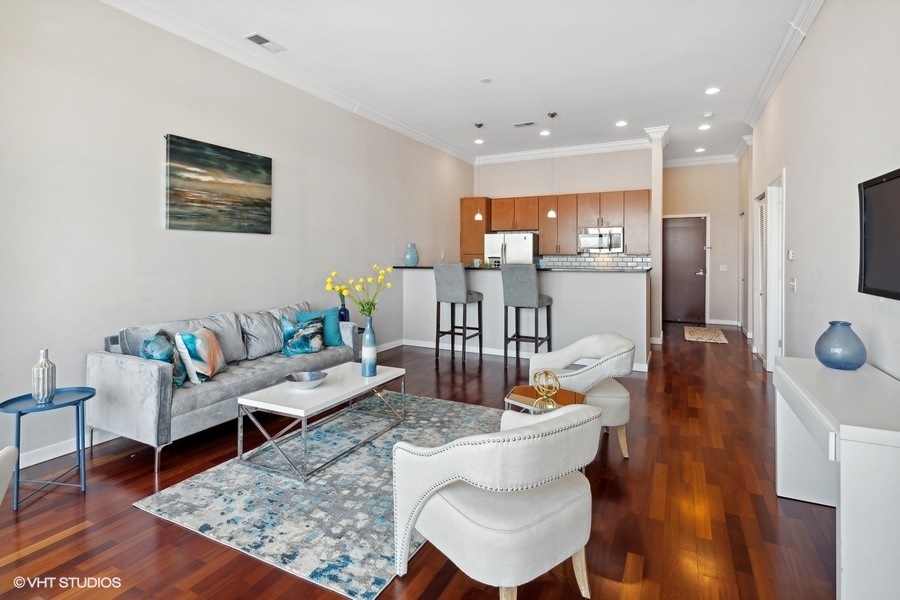 3920 North Sheridan Road, Unit 504 Chicago, IL 60613 - Photo 6 of 21 a living room with furniture and a wooden floor