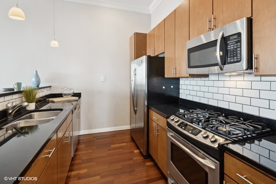 3920 North Sheridan Road, Unit 504 Chicago, IL 60613 - Photo 9 of 21 a kitchen with a stove and a microwave