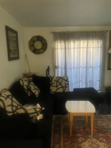 a table room with a couch and a potted plant