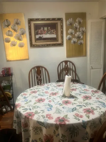 a bedroom with a bed and painting on the wall