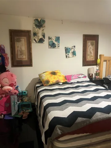 a bedroom with a bed and dresser