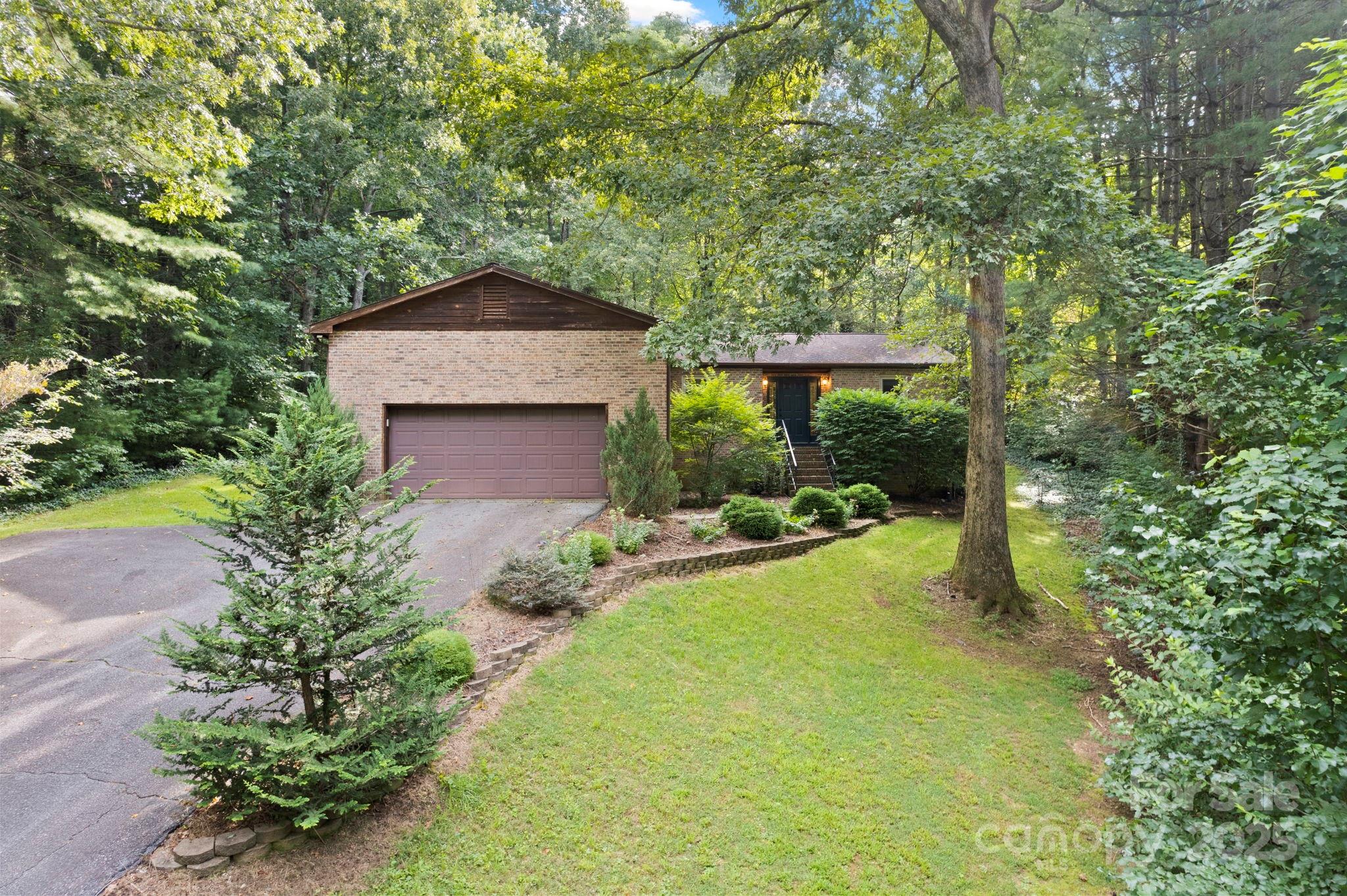 207 Mint Way Flat Rock, NC 28731 - Photo 1 of 27 a view of a backyard with table and chairs and potted plants