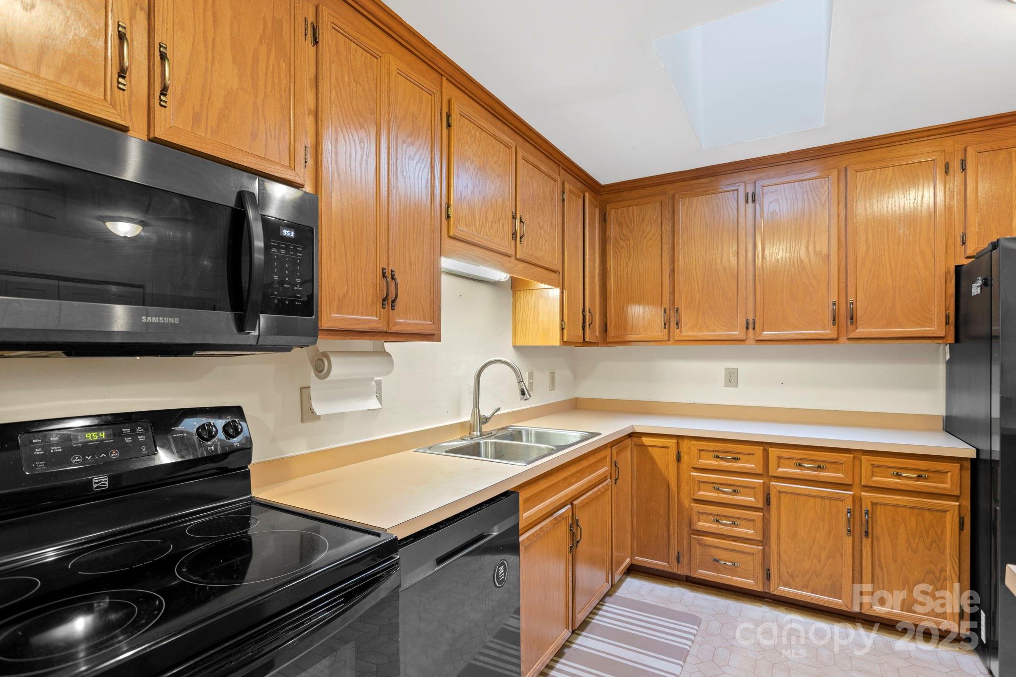 207 Mint Way Flat Rock, NC 28731 - Photo 12 of 27 a kitchen with wooden cabinets and a stove top oven