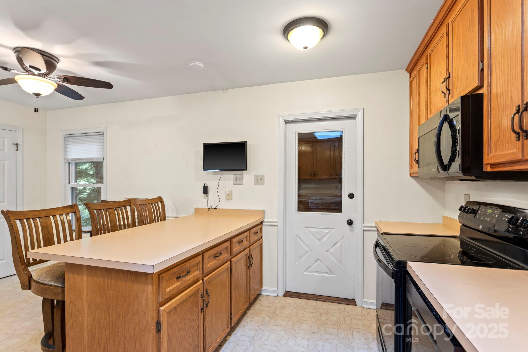 207 Mint Way Flat Rock, NC 28731 - Photo 13 of 27 a view of a kitchen with a sink and a microwave
