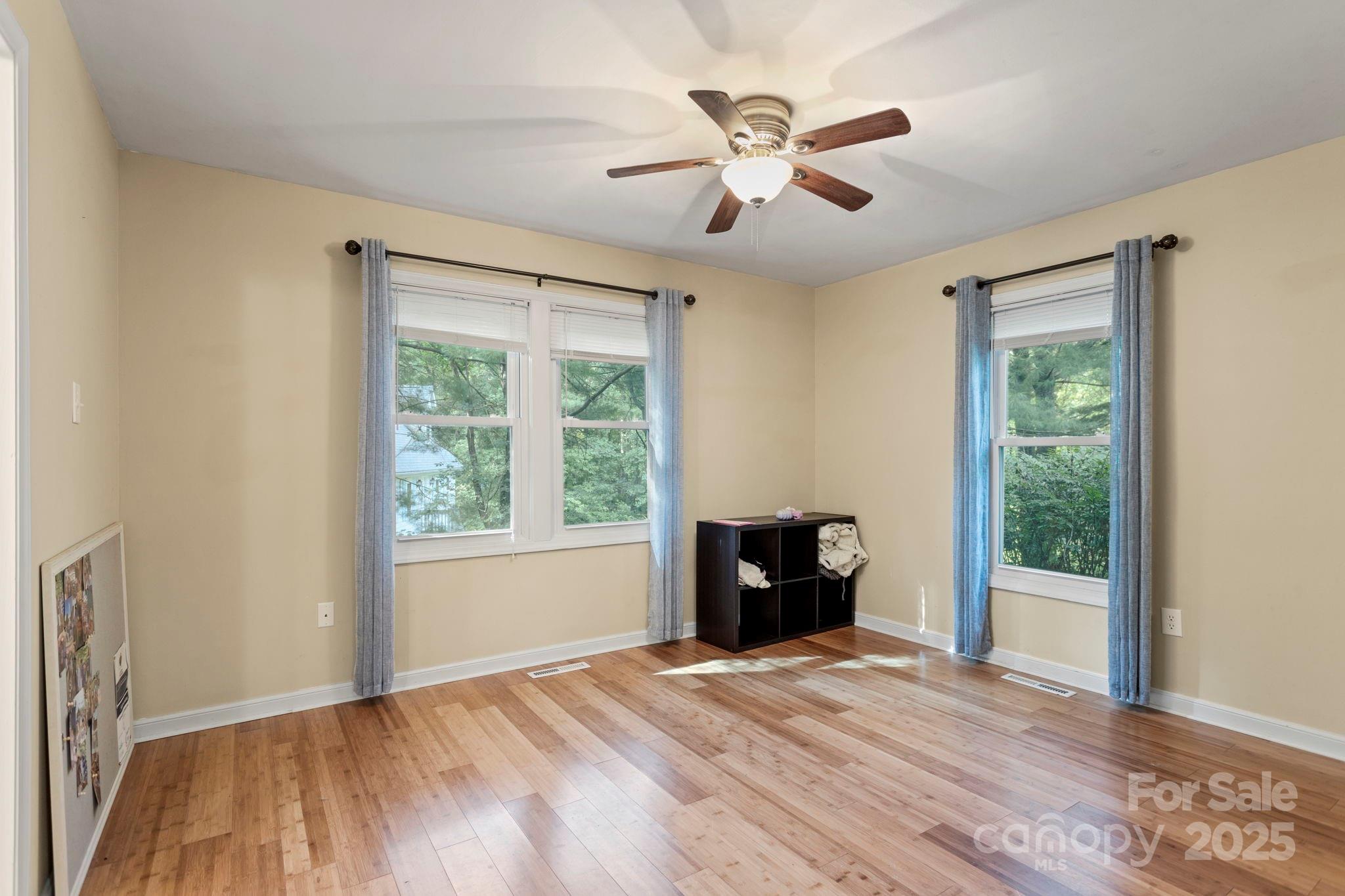207 Mint Way Flat Rock, NC 28731 - Photo 14 of 27 a view of empty room with wooden floor and fan