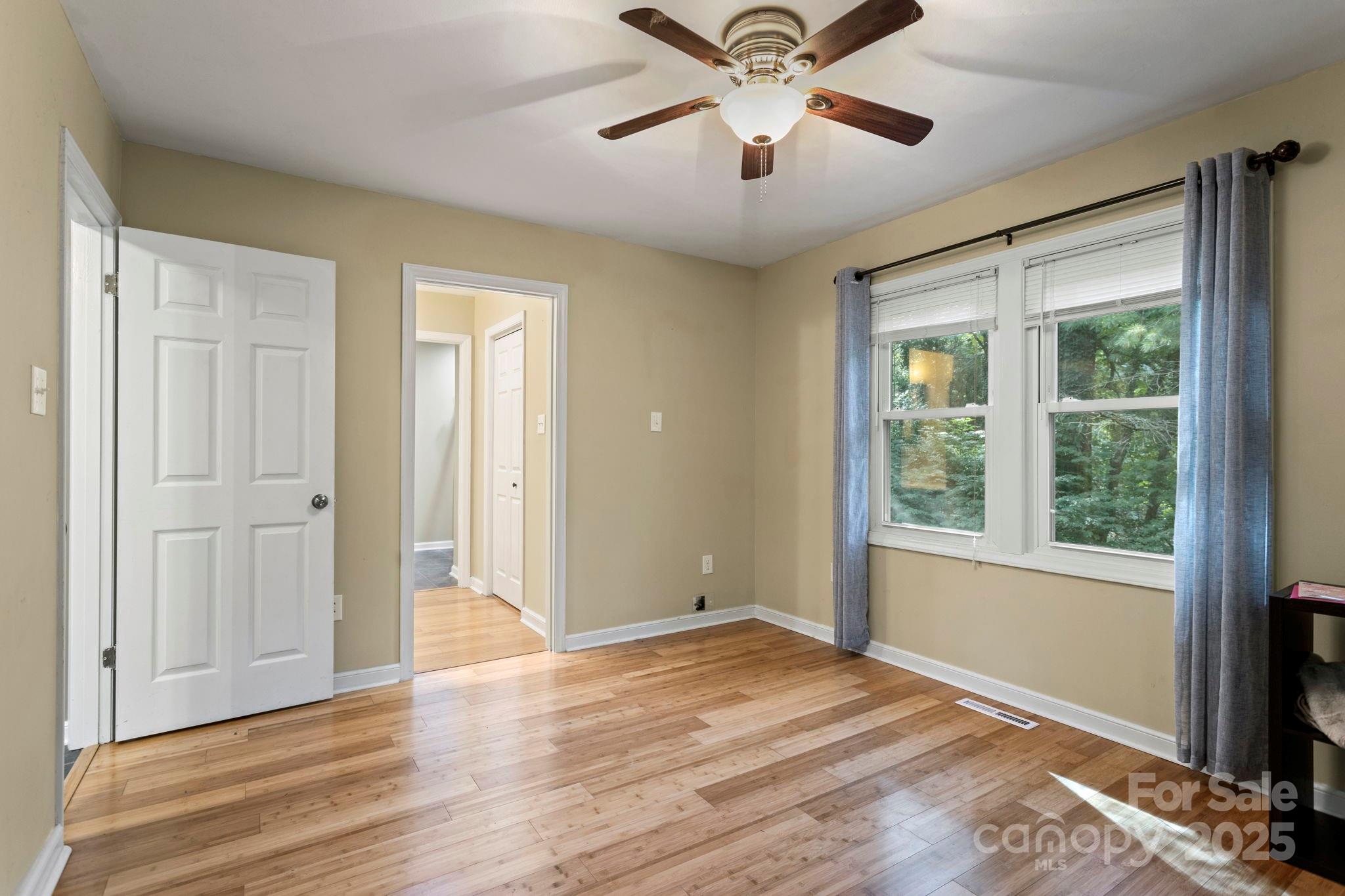 207 Mint Way Flat Rock, NC 28731 - Photo 15 of 27 an empty room with wooden floor chandelier and windows